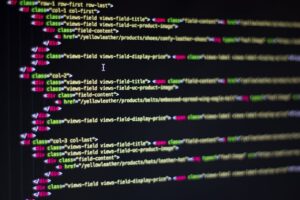 Home Detailed close-up of HTML code on a computer monitor, showcasing web development.
